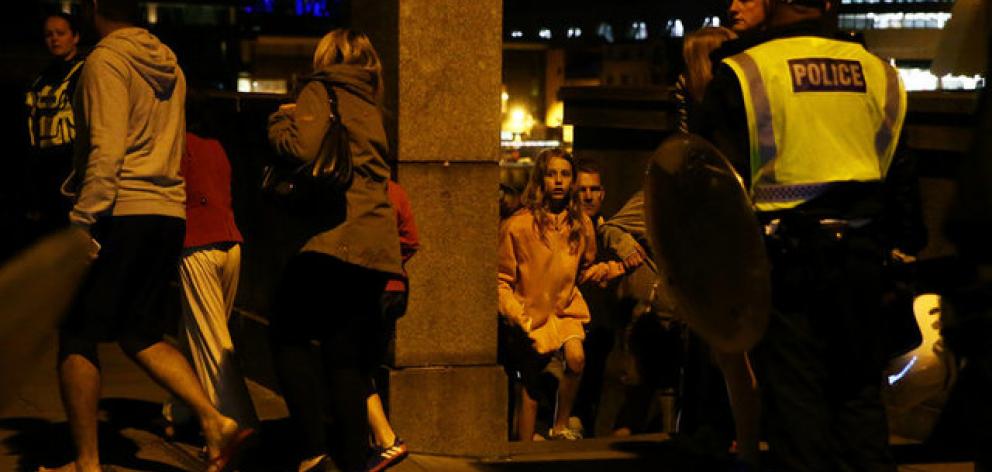 People flee as police attend to an incident near London Bridge in London. Photo: Reuters