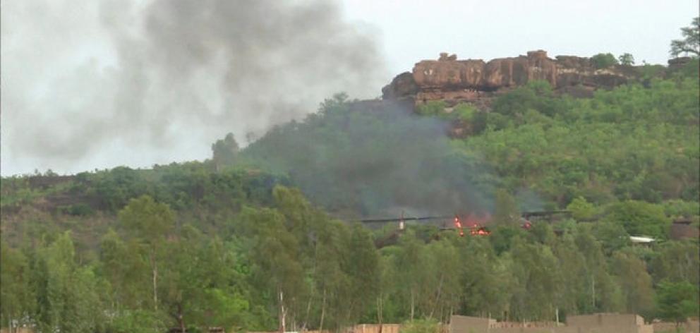 Flames rise following an attack where gunmen stormed Le Campement Kangaba resort in Dougourakoro, to the east of the capital Bamako, Mali. Photo: Reuters