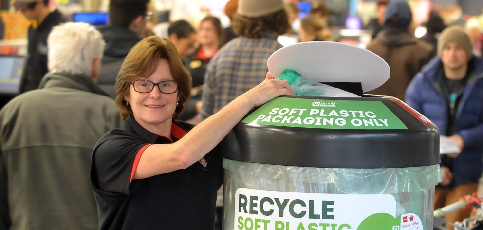 Gardens New World duty manager Debbie Lloyd places some plastic bags in a new receptacle launched...