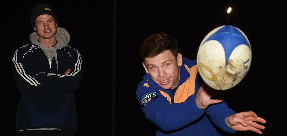 Taieri halfbacks Ryan and Kurt Hammer (passing the ball) during training at Peter Johnstone Park on Tuesday night. Photo: Peter McIntosh