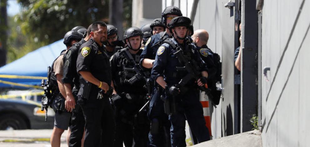Police officers prepare to enter a UPS facility after a gunman opened fire inside the building in San Francisco. Photo: Reuters