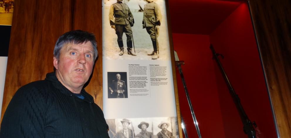 Peter Trevathan next to a display in Toitu Otago Settlers Museum of New Zealand volunteers who fought in the South African War. PHOTO: JOSHUA RIDDIFORD
