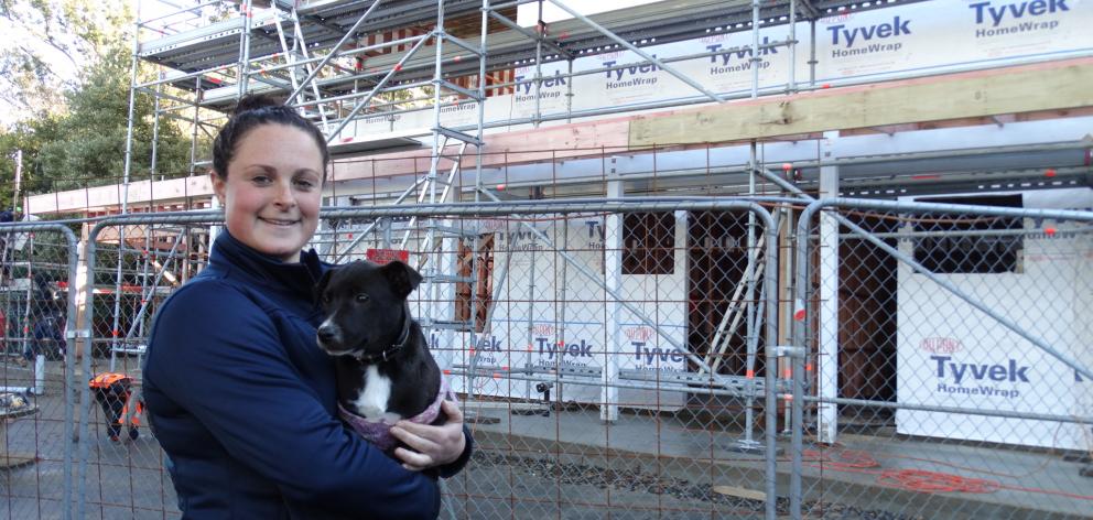 SPCA Otago animal care manager Hannah Hunsche and pup Max look over progress on building the new education and animal reception building at the Opoho animal shelter. PHOTO: Brenda Hardwood