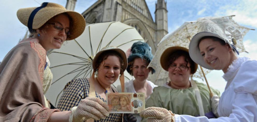 People in period costume pose with the new £10 note featuring Jane Austen. Photo: Reuters People in period costume pose with the new £10 note featuring Jane Austen. Photo: Reuters