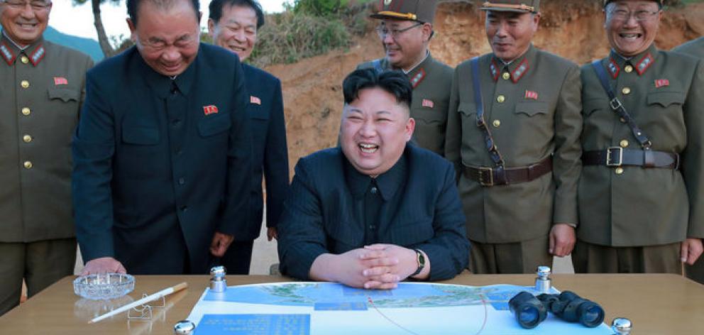 North Korean leader Kim Jong Un reacts during the long-range strategic ballistic rocket Hwasong-12 (Mars-12) test launch. Photo: Reuters