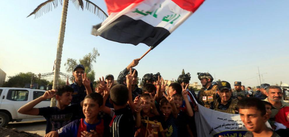 Iraqi Federal police and boys celebrate in West Mosul. Photo: Reuters