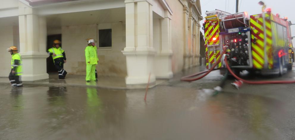 Weston Volunteer Fire Brigade members pump  out  the car park next to the old Weston Memorial...