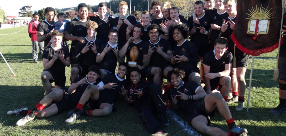 Waitaki Boys’ High School’s First XV celebrates with the Leo O’Malley Memorial Trophy after...