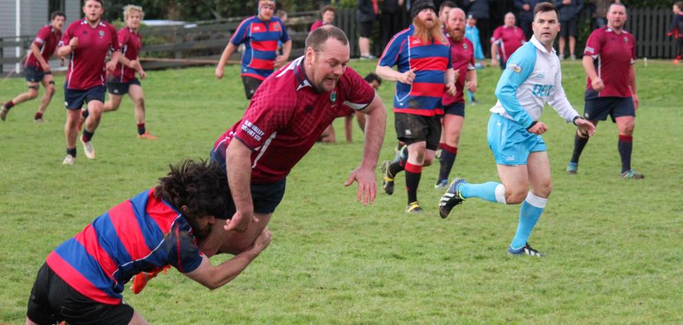 Clutha Valley’s Aaron Gouman is lowered by Owaka’s Thomas Gray in a southern region club match in...