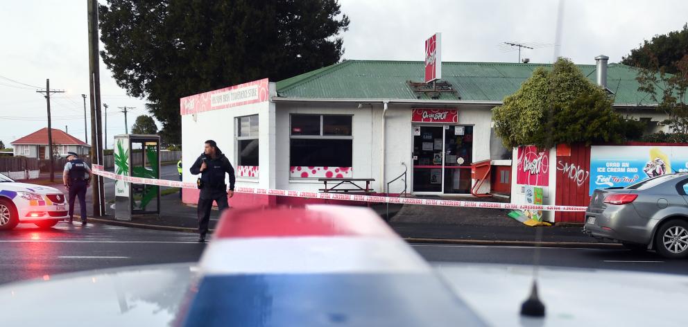 Police at the scene of an attempted robbery of the Halfway Bush Convenience Store at the...