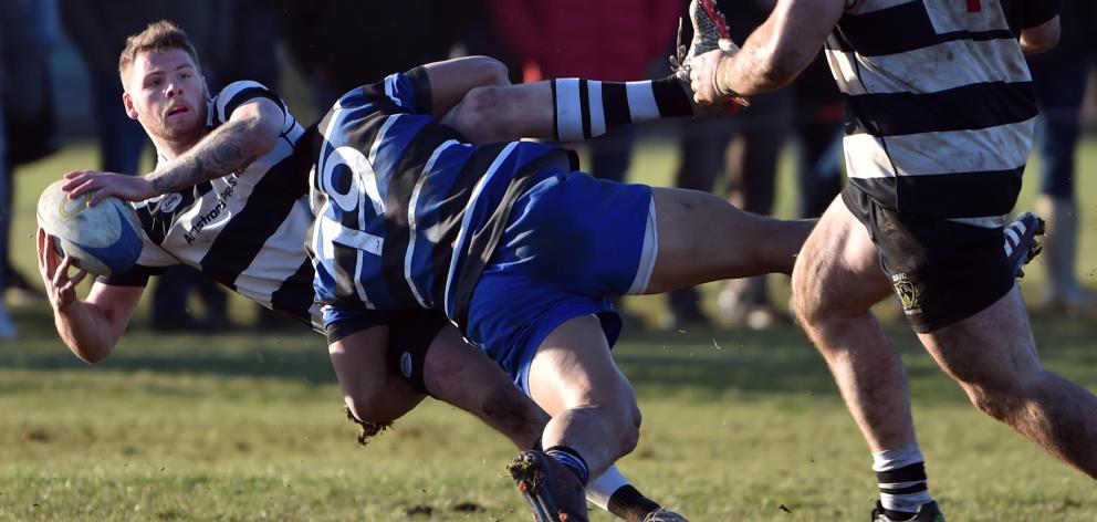 Kaikorai loose forward Iakopo Petelo Mapu nails Southern winger Josh Buchan in a good tackle...