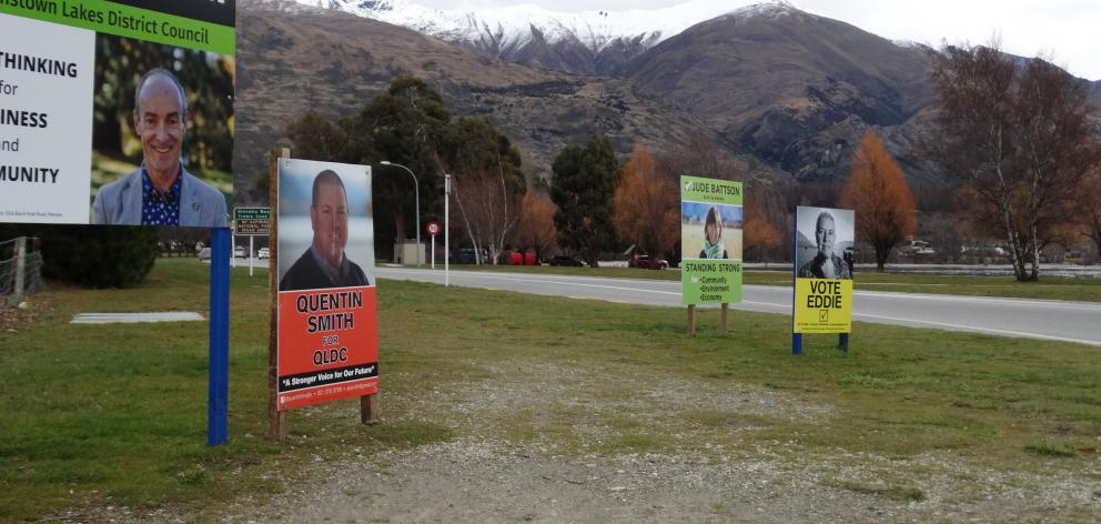 Billboards advertise candidates in the Wanaka by-election. Photo: Tim Miller.