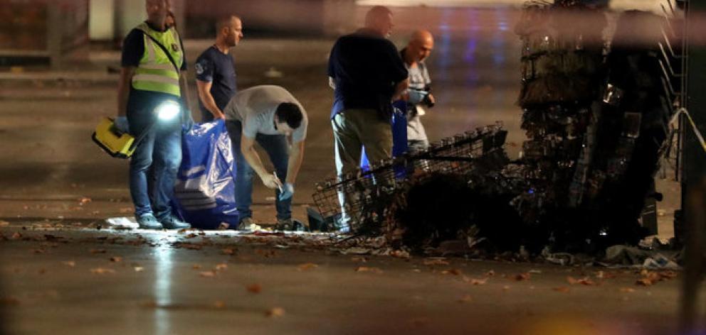 Forensic police officers search for clues near the area where a van crashed into pedestrians at Las Ramblas in Barcelona. Photo: Reuters