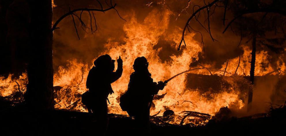 Firefighters battle the Ponderosa Fire east of Oroville. Photo: Reuters