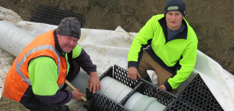 Central Machinery Hire staff  Peter Donovan (left)  and Josh Perkins, both of Wanaka, are laying...