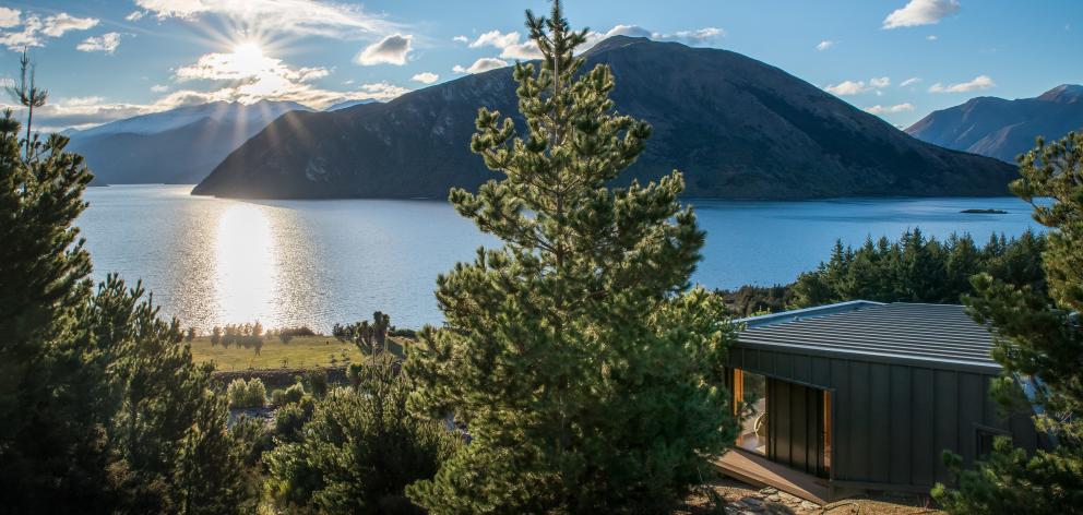 Tucked into the hillside and accessed via a schist path, the guest cottage has an amazing view.