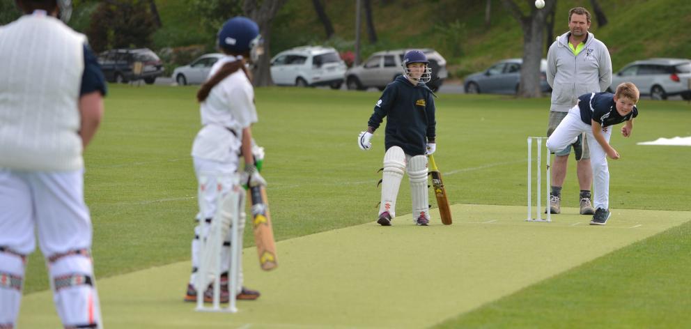 Jackson Milne, of the Kaikorai Sonics, bowls to Taieri Sparkles batsmen Grace Cotter during a...