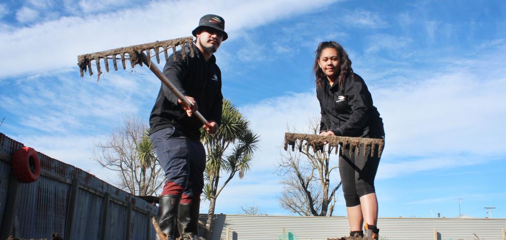 Telford students Louis Pene and Monika Dean rake the Balclutha Community Garden as part of a...