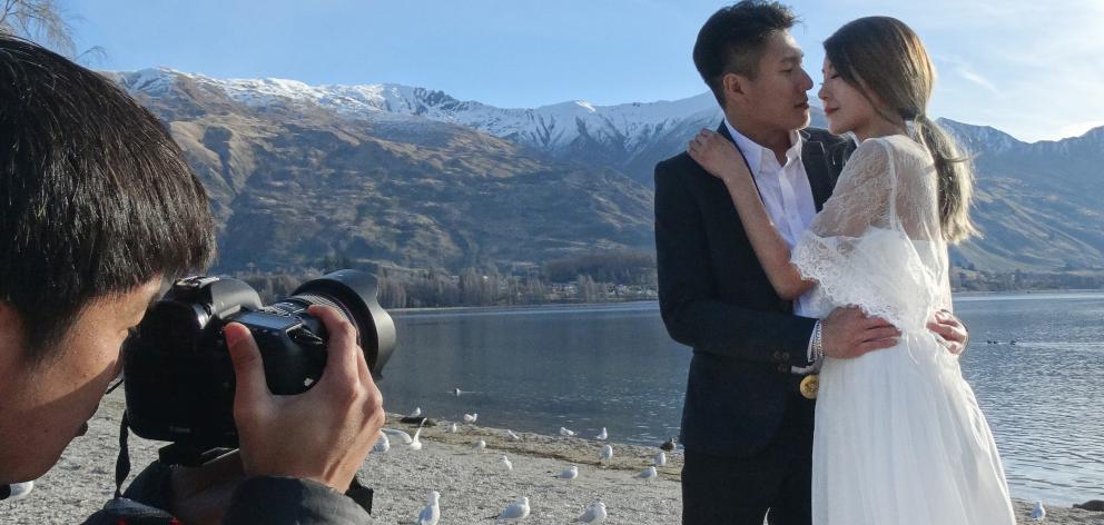 Almost newlyweds Colin Chiam and Joy Celyn Kah, of Malaysia, pose for a photo in front of Lake...