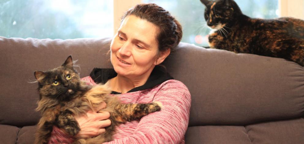 Kate Ferris with two of her cats,  Ash (left) and Storm. They are vaccinated and desexed but not ...