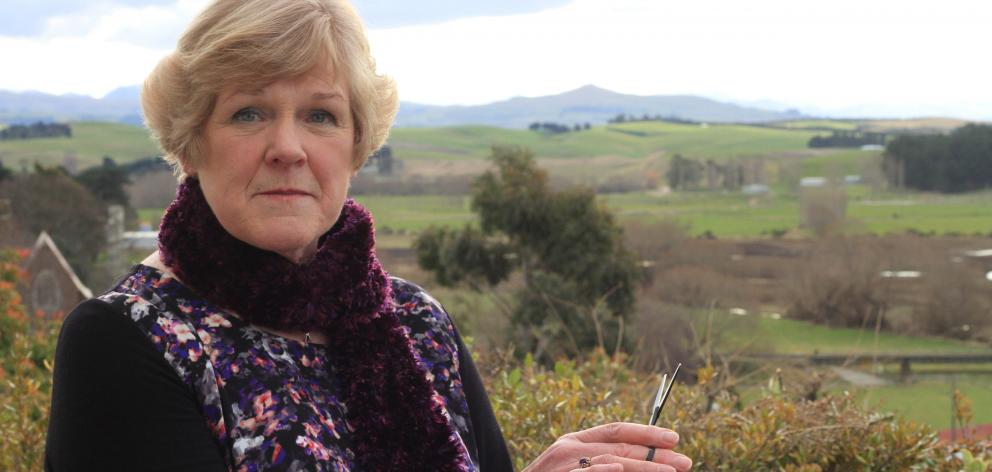 Diana McKay (70), holding a $1000 pair of Japanese hairdressing scissors in her garden, had been...