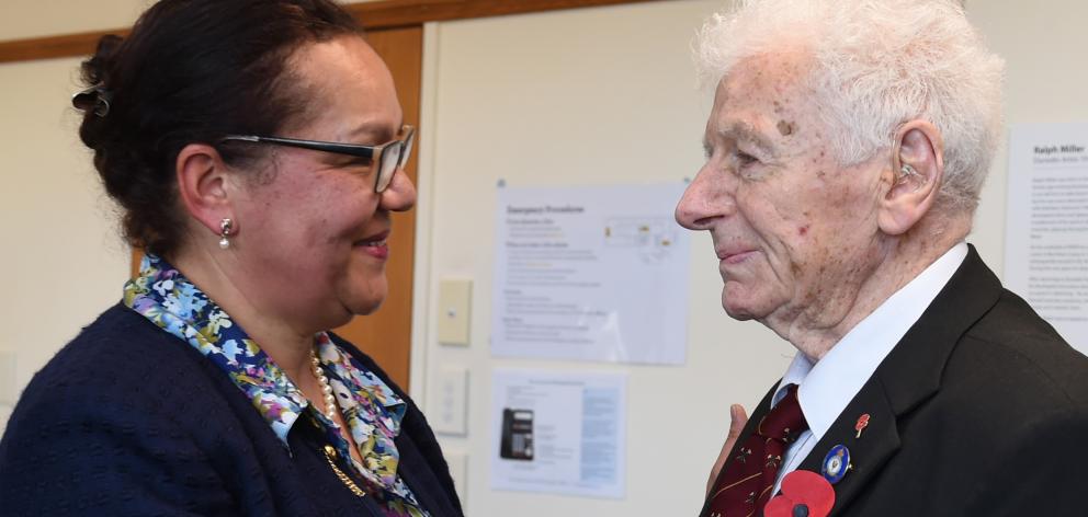 Former 75 Squadron navigation officer, Emeritus Archdeacon Neville Selwood, receives the Legion...