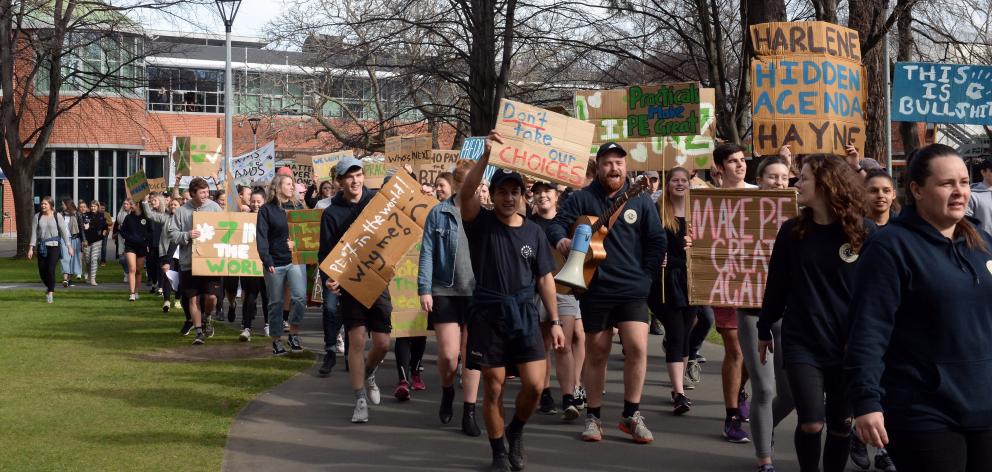 Hundreds marched across the campus in opposition to a plan cut staff and papers at the School of...