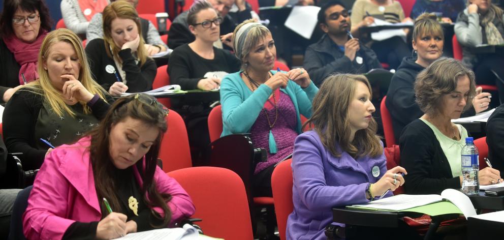 People listen and take notes during the suicide prevention workshop in Dunedin on Saturday. Photo...