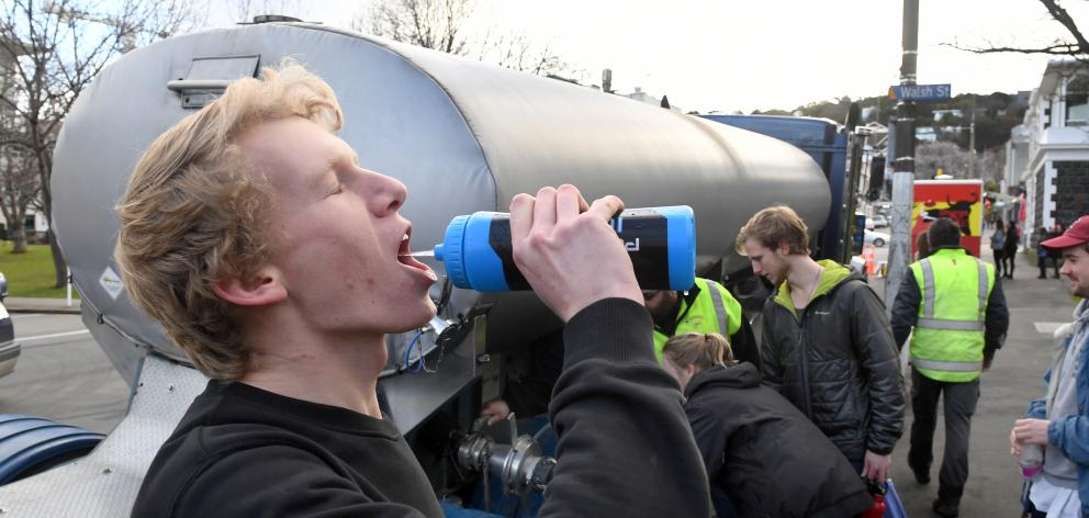 University of Otago student James Tweed drinks water from a tanker during the city's water contamination scare yesterday. Photo: Stephen Jaquiery