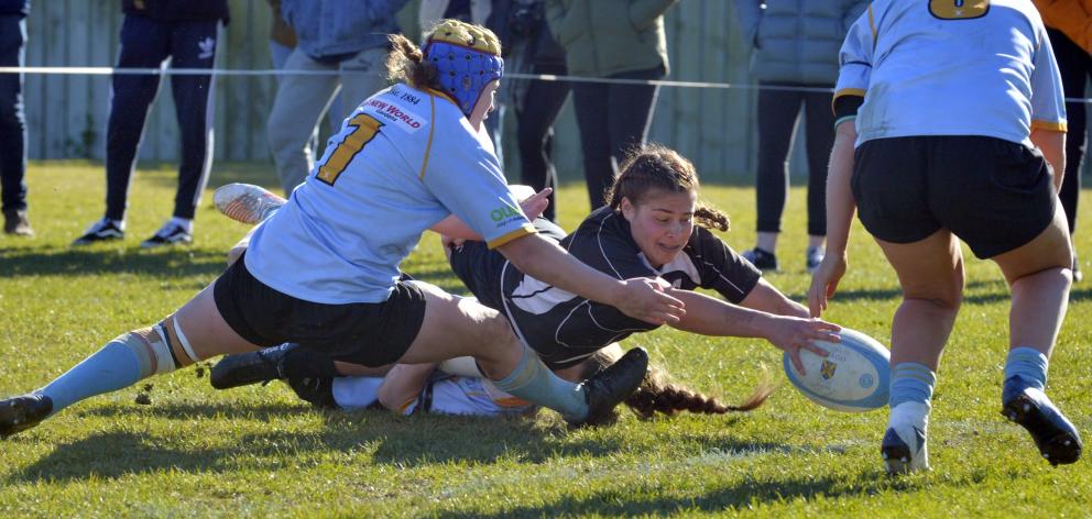 Pirates first five-eighth Celine Timoko reaches out to score a try during the women’s club final at Kettle Park on Saturday. University prop Nicky Whitworth is unable to stop her scoring. Photo: Gerard O'Brien