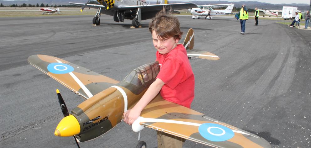 Flynn Millar (9), of Alexandra, holds a model Curtiss P-40N Kittyhawk at the Wings ’n’ Wheels...