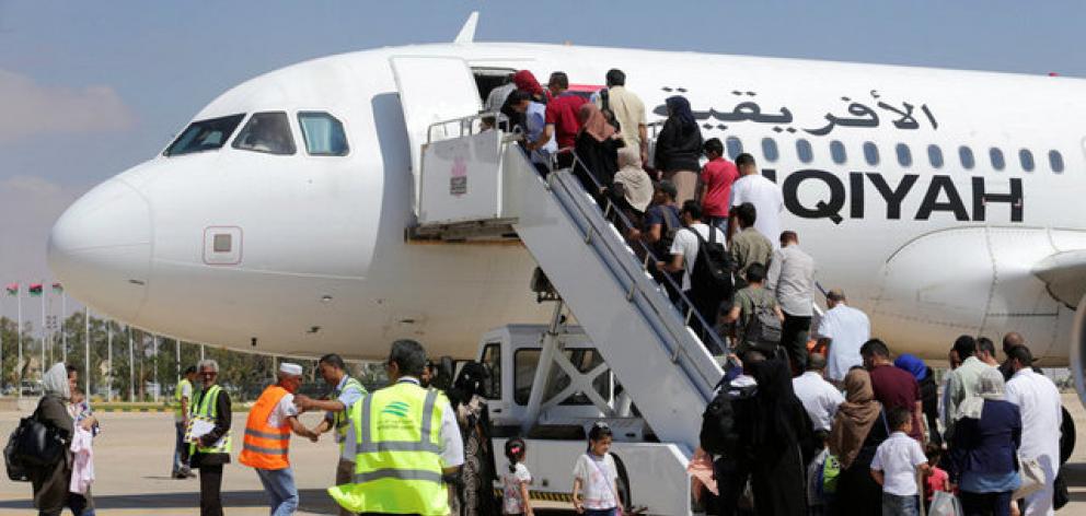 Passengers board a flight at Benina airport east of Benghazi in Libya. Photo: Reuters