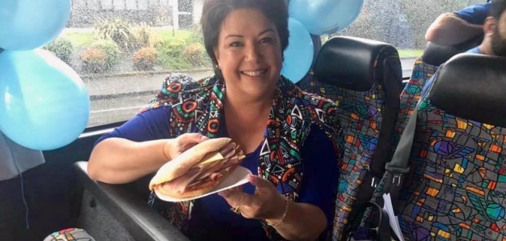 Paula shows off her panini, wearing a jacket that blends very well with the bus seats. Photo / Facebook