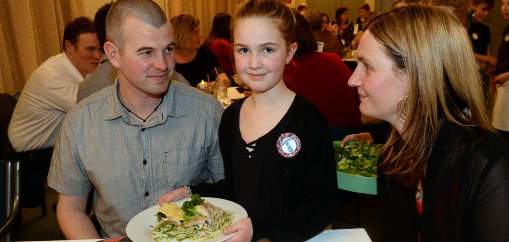 Mineeka Macshane-Camp (8)  serves a meal to her parents, Tim Camp and Charlotte Macshane, at  the...