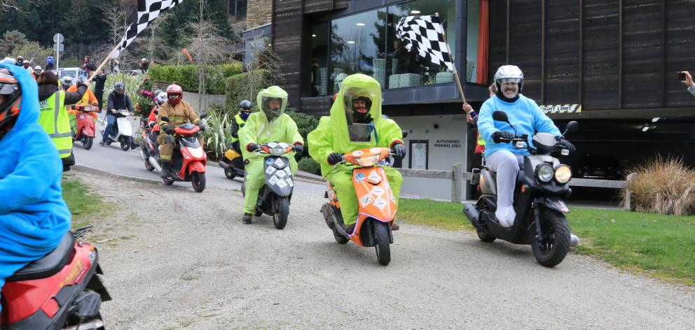 Participants in the scooter charity ride arrive at the Queenstown Rec Grounds on Saturday. Photo:...