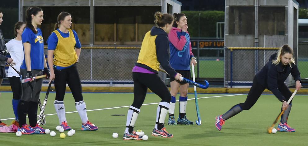 Southern Storm’s Emily McNaughtan pushes the ball forward, with  team mates Alice Sharples (left)...