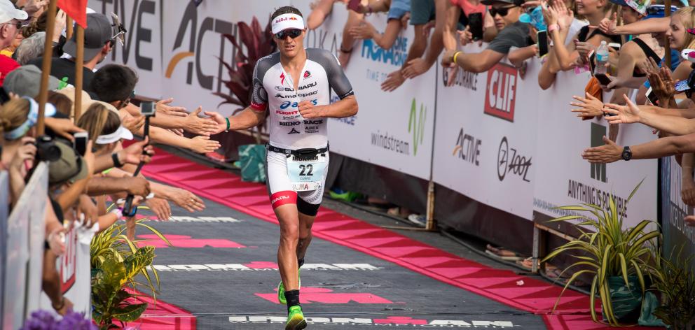 Braden Currie nears the finish line of the  Ironman world championships in Kona, Hawaii,...
