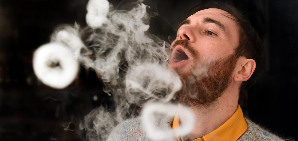 Dunedin e-cigarette store Vapourium account manager Cody Peneamene blows vapour rings from a...