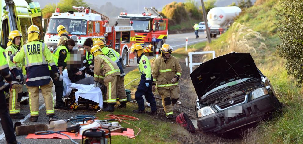 Emergency services tend to the driver of a four-wheel-drive, who was trapped in his vehicle after...