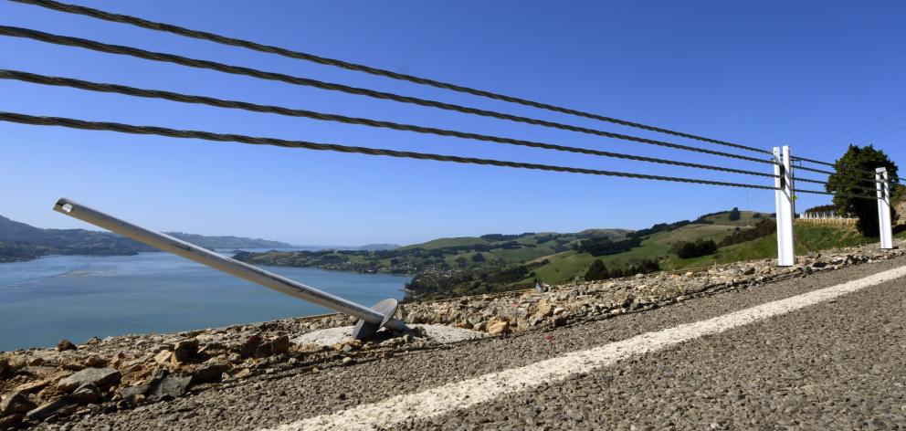 A wire barrier at the edge of a steep drop on Highcliff Rd appears to have saved its first...