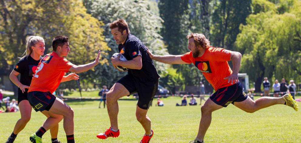 Arrowtown team captain Aiden Winter touches former All Black captain Richie McCaw during the...