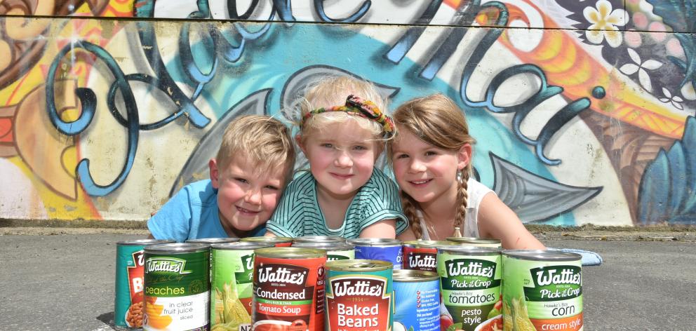Balaclava School pupils Quin Parker, Mae Wilson and Sienna Sainsbury (all 5) with some of the cans they have collected. Photo: Gregor Richardson. 