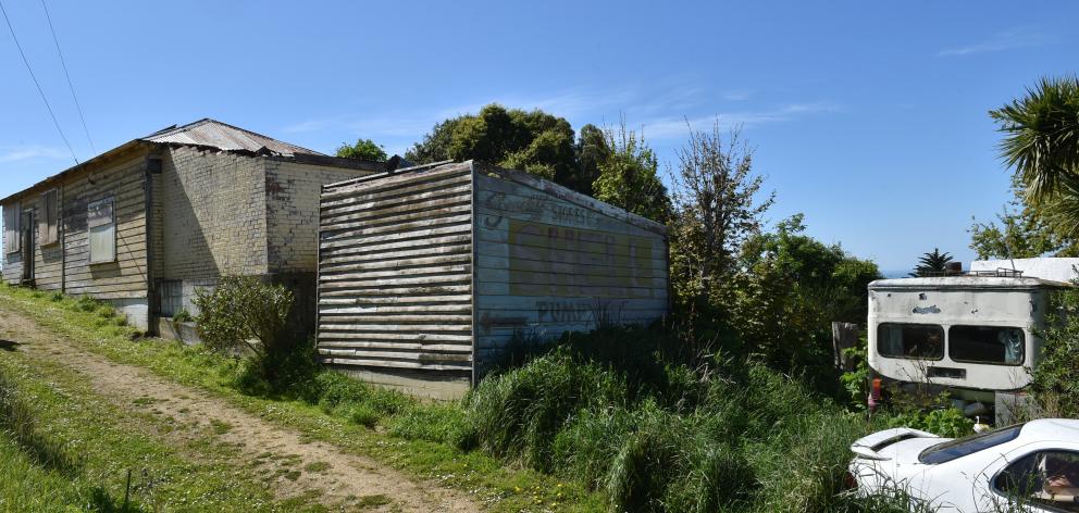 Only a couple of metres divided Findlay’s house bus and Ms Comerford’s dilapidated home.