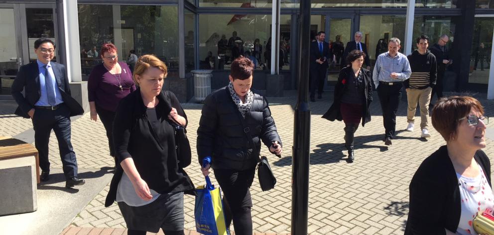 University of Otago staff leave a meeting today where they were told 160 jobs would be cut. Photo: Gregor Richardson
