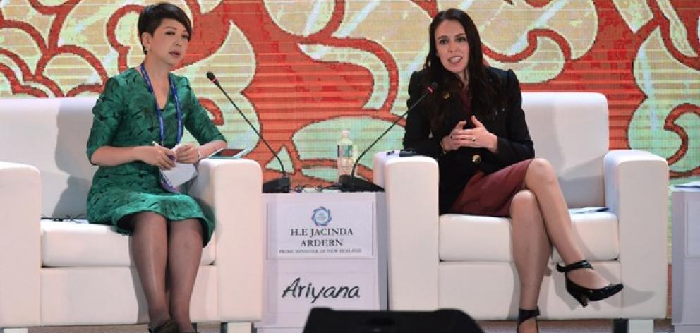 PM Ardern speaks with session moderator Tian Wei. Photo: Reuters