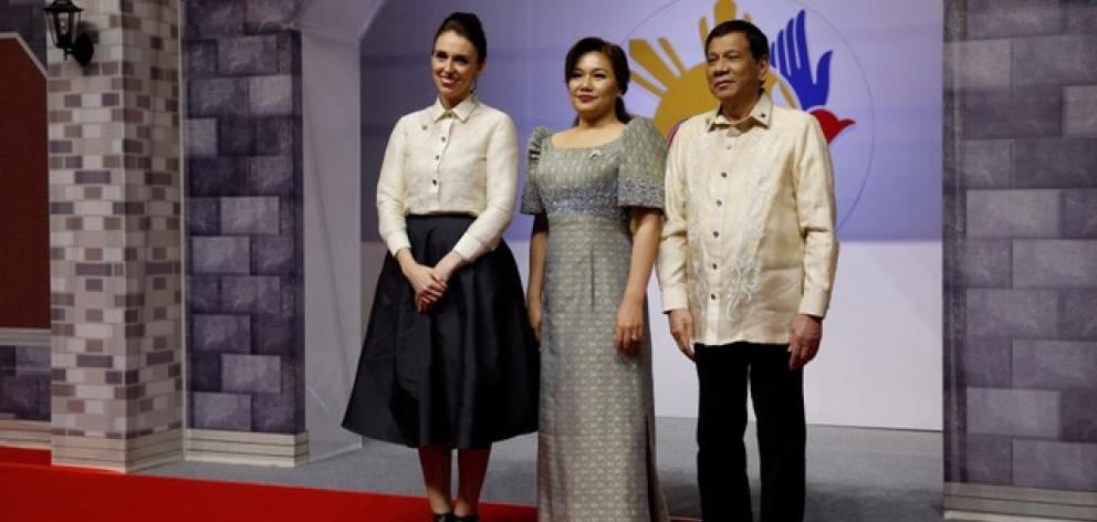 Jacinda Ardern poses with Philippines President Rodrigo Duterte and Honeylet Avancena as she attends the ASEAN Summit gala. Photo: Reuters
