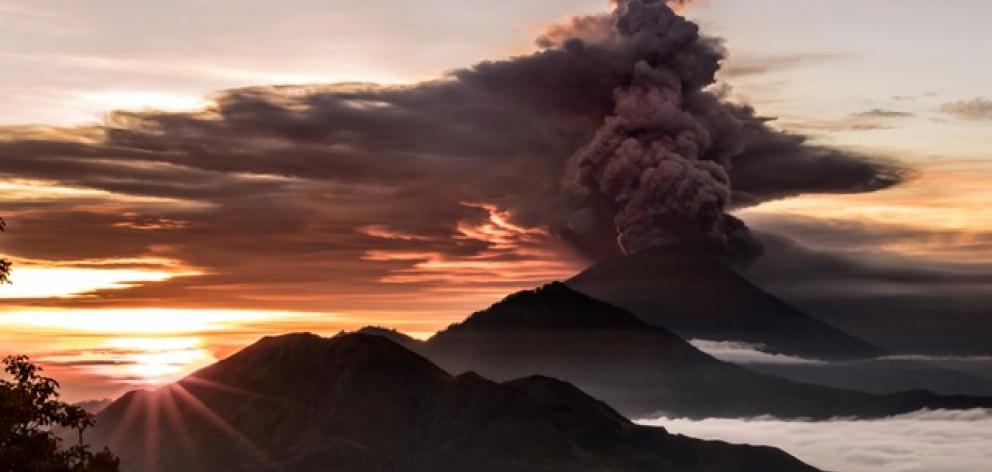 Mount Agung volcano is seen spewing smoke and ash in Bali. Photo: Emilion Kuzma-Floyd @eyes_of_a_nomad via Reuters