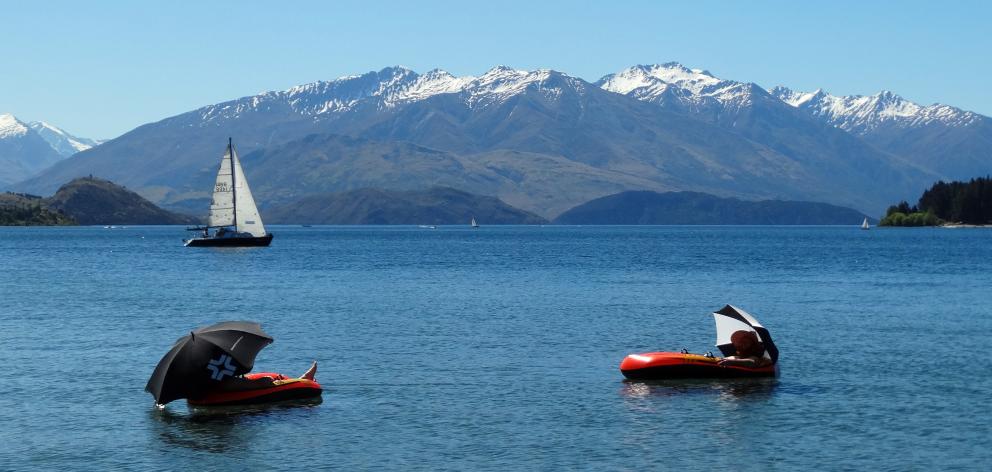 William Stagg (left) and James Wheeler-Arthurs, of Mount Maunganui, float the afternoon away on...