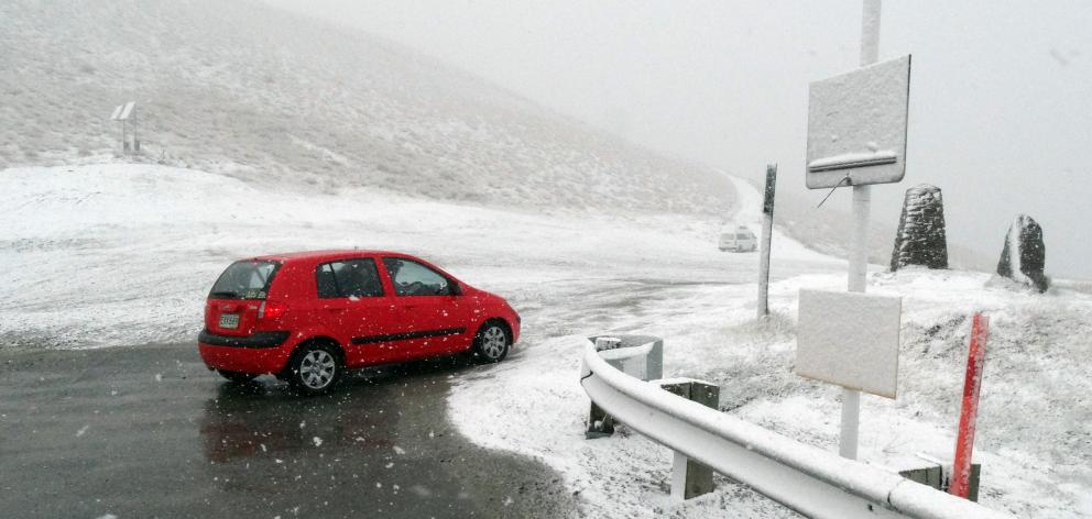 A driver stops at the top pull-off bay of the Crown Range  road, between Queenstown and Wanaka,...