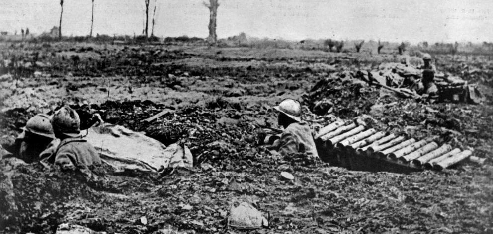 French troops shelter in shell-holes on the battlefield near Braschoote, Flanders. — Otago...